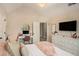Bedroom featuring plush bedding, study desk, and modern lighting at 812 Nevis Way, Mcdonough, GA 30253