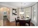 Dining area with round table, modern lighting, and large windows offering natural light at 812 Nevis Way, Mcdonough, GA 30253