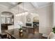 Elegant dining room with arched doorways, modern light fixture, and hardwood floors at 812 Nevis Way, Mcdonough, GA 30253