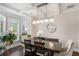 Bright dining room with modern light fixture, wainscoting, and large windows at 812 Nevis Way, Mcdonough, GA 30253