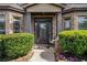 Charming front entryway with a dark-colored door, sidelights, and decorative landscaping at 812 Nevis Way, Mcdonough, GA 30253