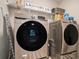 Efficient laundry room with modern appliances, shelving, and ample space for laundry tasks at 812 Nevis Way, Mcdonough, GA 30253