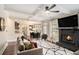 Open concept living room with fireplace, coffered ceilings, and a view of the dining area at 812 Nevis Way, Mcdonough, GA 30253