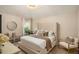 Elegant primary bedroom featuring a tufted headboard, soft neutral tones, and ample natural light for a serene retreat at 812 Nevis Way, Mcdonough, GA 30253