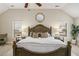 Bright main bedroom with a decorative wooden headboard, neutral color scheme, and bedside tables at 812 Nevis Way, Mcdonough, GA 30253