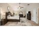 Spacious main bedroom with decorative dresser, ceiling fan, neutral colors, and a large rug at 812 Nevis Way, Mcdonough, GA 30253