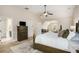 Spacious main bedroom featuring a ceiling fan, sitting area, and ensuite bathroom at 812 Nevis Way, Mcdonough, GA 30253