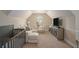 Sitting area with a crib and media center at 812 Nevis Way, Mcdonough, GA 30253