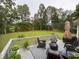 Large deck with outdoor seating and a lush green backyard at 2507 Fairweather Se Ct, Conyers, GA 30013