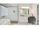 Modern bathroom featuring a glass shower, soaking tub, and vanity with granite countertops at 2507 Fairweather Se Ct, Conyers, GA 30013
