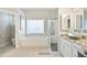 Bright bathroom features shower, soaking tub, vanity, and vessel sink at 2507 Fairweather Se Ct, Conyers, GA 30013