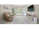 Bright bonus room featuring large windows, cozy seating, and modern decor at 2507 Fairweather Se Ct, Conyers, GA 30013