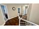 Hallway featuring hardwood flooring, a staircase, and neutral wall paint at 2507 Fairweather Se Ct, Conyers, GA 30013