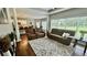 Open concept living room with hardwood floors, recessed lighting, and oversized rug at 2507 Fairweather Se Ct, Conyers, GA 30013