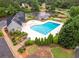 Community pool with a clubhouse, tennis courts, mature landscaping, and ample parking at 2507 Fairweather Se Ct, Conyers, GA 30013