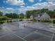 Aerial view of tennis courts with a pool and community buildings in the background at 2507 Fairweather Se Ct, Conyers, GA 30013