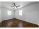 Clean, bright bedroom featuring a ceiling fan, flooring, and two windows at 75 Meldon Se Ave, Atlanta, GA 30315