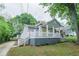 Charming bungalow with a large front porch, gray siding, and a well-maintained lawn and garden at 75 Meldon Se Ave, Atlanta, GA 30315