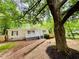 Inviting home nestled in a lush green setting with a picturesque walkway and mature trees at 8 Dixie Dr, Stockbridge, GA 30281