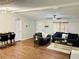 Spacious living area featuring hardwood floors, comfortable seating, and modern lighting fixtures at 8 Dixie Dr, Stockbridge, GA 30281