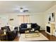 Inviting living room with comfortable sofas, a modern ceiling fan, and an electric fireplace at 8 Dixie Dr, Stockbridge, GA 30281