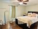 Cozy bedroom with a stylish black bed frame, complementary decor, and natural light at 8 Dixie Dr, Stockbridge, GA 30281