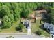 Aerial view of home with well manicured front lawn and long driveway leading to two car garage at 1625 Brisbane Dr, Dacula, GA 30019