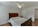 Inviting bedroom with ceiling fan and wood floors featuring a sleigh bed and neutral paint at 1625 Brisbane Dr, Dacula, GA 30019