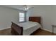 Cozy bedroom with wood flooring, a comfortable sleigh bed, and a ceiling fan for added comfort at 1625 Brisbane Dr, Dacula, GA 30019