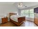 Comfortable bedroom with a wood bed frame, matching furniture, and a view of the outdoors at 1625 Brisbane Dr, Dacula, GA 30019
