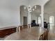 Elegant dining room featuring hardwood floors, chandelier, and a seamless transition to the living area at 1625 Brisbane Dr, Dacula, GA 30019