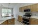 Well-equipped kitchen showcases updated appliances, bright countertops, and a cozy dining nook with natural light at 1625 Brisbane Dr, Dacula, GA 30019