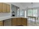 Well-lit kitchen boasts ample counter space, modern appliances, and an adjacent dining area with a large window at 1625 Brisbane Dr, Dacula, GA 30019