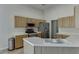 Bright kitchen with stainless steel appliances, light-colored cabinets, and stone tile flooring at 1625 Brisbane Dr, Dacula, GA 30019
