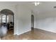 Open living room featuring hardwood floors and an archway leading to another room at 1625 Brisbane Dr, Dacula, GA 30019