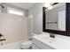 Updated bathroom featuring shower-tub combo, and framed mirror over vanity at 1650 Berryhill Rd, Cumming, GA 30041