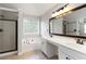 Bright bathroom with double vanity, separate shower, soaking tub, and neutral tile flooring at 1650 Berryhill Rd, Cumming, GA 30041