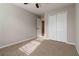 Bedroom with neutral carpet, fresh paint, and double door closet for ample storage at 1650 Berryhill Rd, Cumming, GA 30041