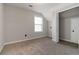 Bedroom with a window that brings in natural light and a closet for storing belongings at 1650 Berryhill Rd, Cumming, GA 30041