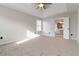 Bright main bedroom boasts natural light, plush carpeting, and a modern ceiling fan at 1650 Berryhill Rd, Cumming, GA 30041