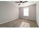 A simple bedroom featuring neutral walls, carpeted flooring, and natural light at 1650 Berryhill Rd, Cumming, GA 30041