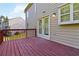 Wooden deck attached to a tan home, complete with a window and French doors at 1650 Berryhill Rd, Cumming, GA 30041