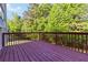 Spacious wooden deck provides a relaxing space with green trees in the background at 1650 Berryhill Rd, Cumming, GA 30041