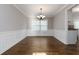 Formal dining room featuring hardwood floors, wainscoting and a stylish chandelier at 1650 Berryhill Rd, Cumming, GA 30041