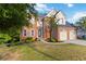 Charming two-story brick home featuring a landscaped yard and an attached two-car garage at 1650 Berryhill Rd, Cumming, GA 30041