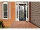 Beautiful front door with decorative glass and brick surround; a charming entry at 1650 Berryhill Rd, Cumming, GA 30041