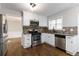 Well-lit kitchen features stainless steel appliances, granite countertops and dark wood flooring at 1650 Berryhill Rd, Cumming, GA 30041