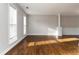 Bright living room with hardwood floors, fresh paint, and natural light from large windows at 1650 Berryhill Rd, Cumming, GA 30041