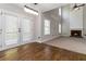 Sun-drenched eat-in area leading to carpeted living room with brick fireplace at 1650 Berryhill Rd, Cumming, GA 30041