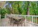 Inviting back deck featuring an outdoor dining area and grill perfect for entertaining guests amid lush landscaping at 1866 Wildwood Ne Pl, Atlanta, GA 30324
